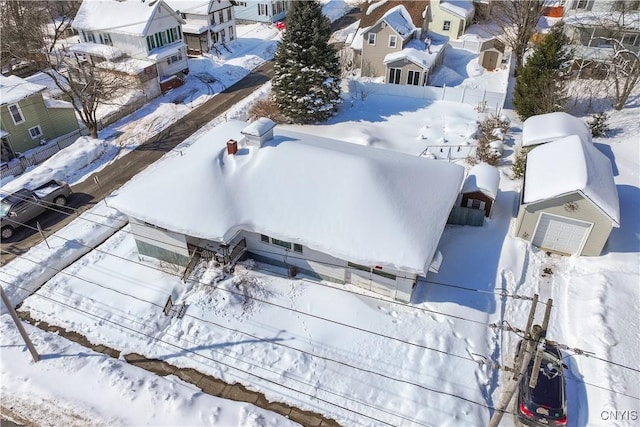 snowy aerial view with a residential view