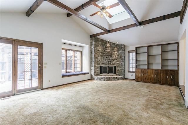 unfurnished living room featuring carpet floors, a healthy amount of sunlight, and a fireplace