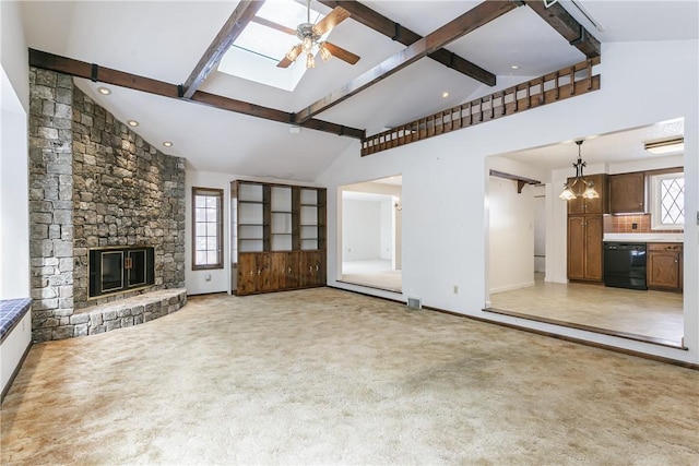 unfurnished living room featuring light carpet, ceiling fan with notable chandelier, beam ceiling, and a stone fireplace