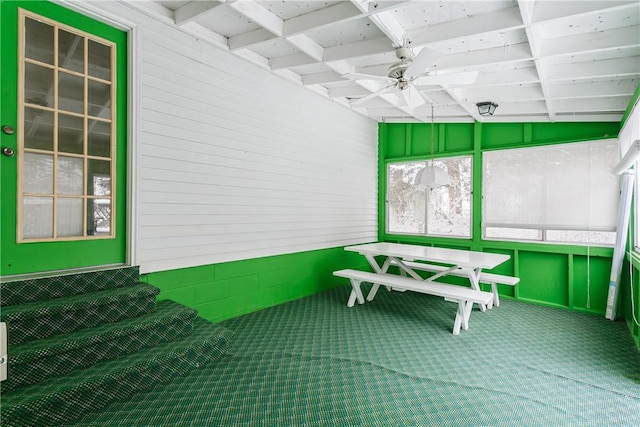 unfurnished sunroom with a ceiling fan