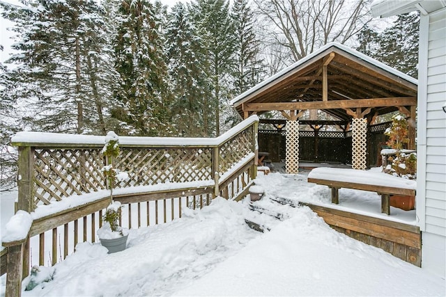 snow covered deck with fence and a gazebo