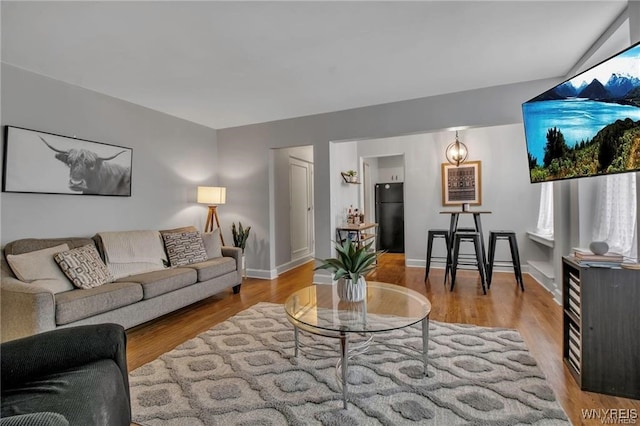 living room featuring baseboards and wood finished floors