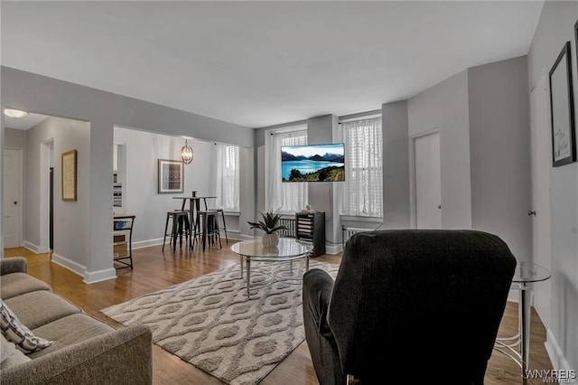 living room featuring light wood finished floors and baseboards