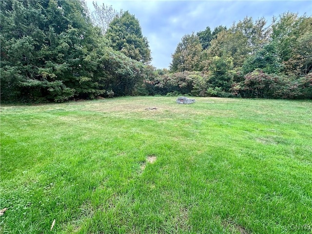 view of yard with a fire pit