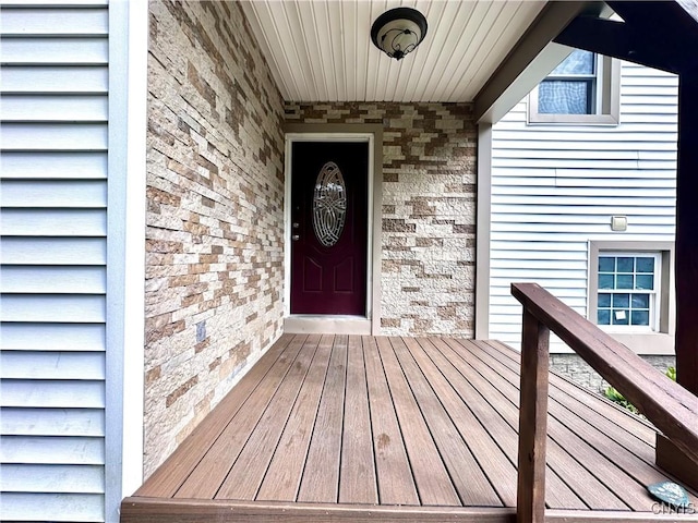 view of exterior entry featuring brick siding