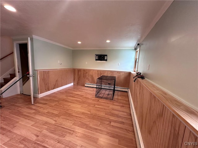 unfurnished room featuring a wainscoted wall, stairway, wood finished floors, crown molding, and recessed lighting