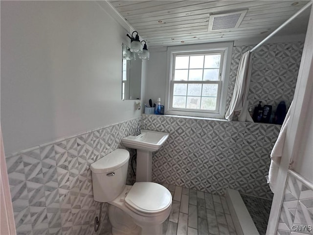 full bath featuring wooden ceiling, toilet, a wainscoted wall, visible vents, and a stall shower