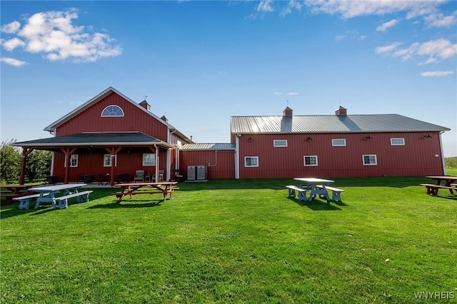 rear view of house with a yard