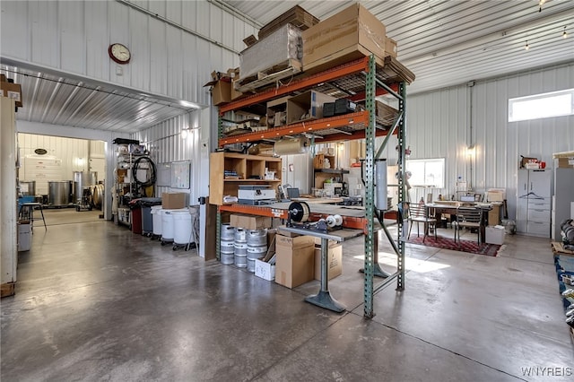 garage featuring metal wall and a workshop area