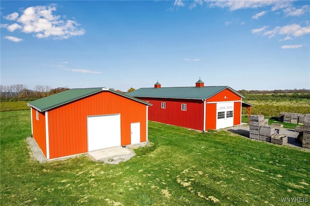 view of pole building with a yard and driveway