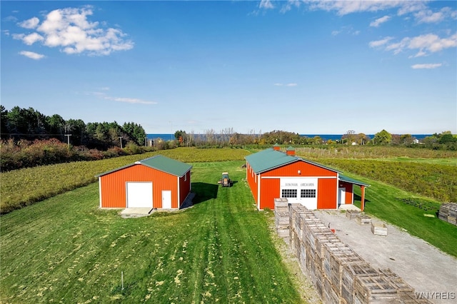 view of pole building featuring a yard, a rural view, and driveway