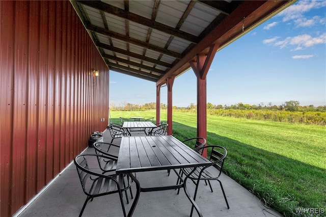 view of patio / terrace featuring outdoor dining space and a rural view