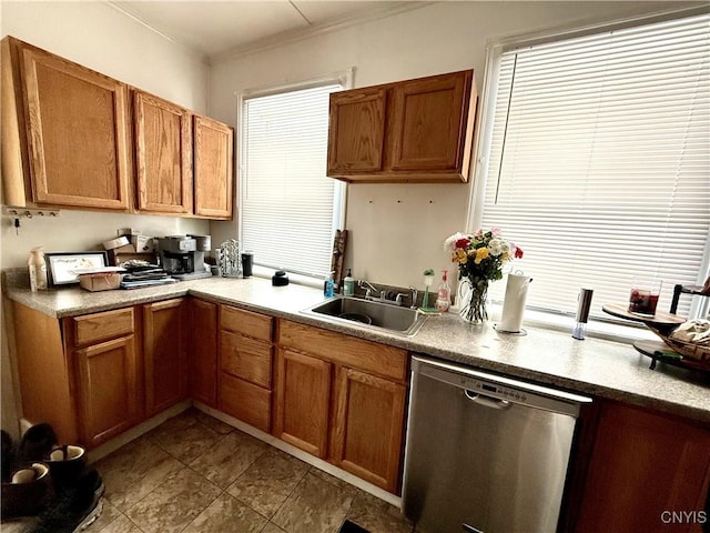 kitchen featuring brown cabinetry, dishwasher, and a sink