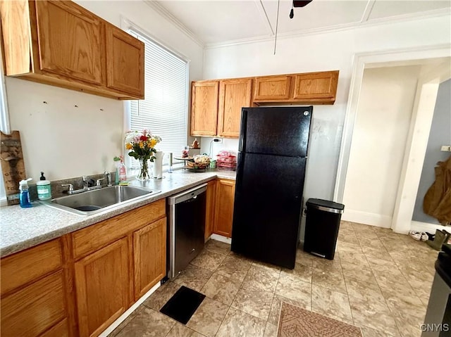 kitchen with a sink, black appliances, brown cabinetry, and light countertops