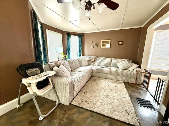 living area featuring ceiling fan, ornamental molding, visible vents, and baseboards