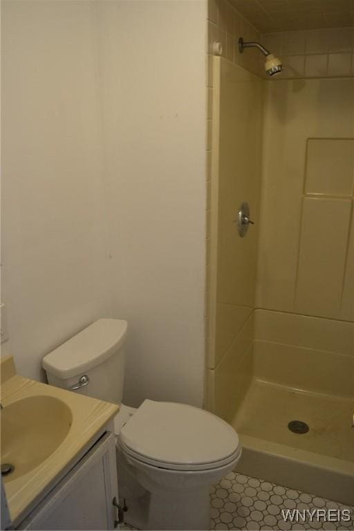 bathroom with vanity, a shower stall, and toilet