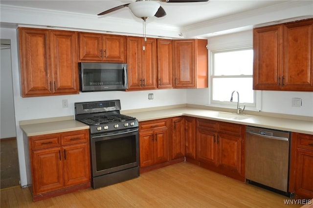 kitchen with dishwasher, light countertops, a sink, and black gas stove