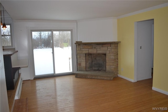 unfurnished living room with a fireplace, crown molding, and wood finished floors