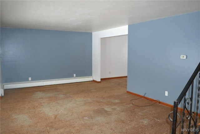 unfurnished room featuring baseboards and a baseboard heating unit