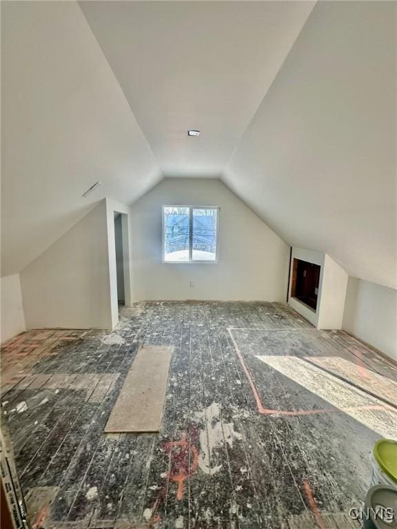 bonus room featuring vaulted ceiling and dark wood-style floors