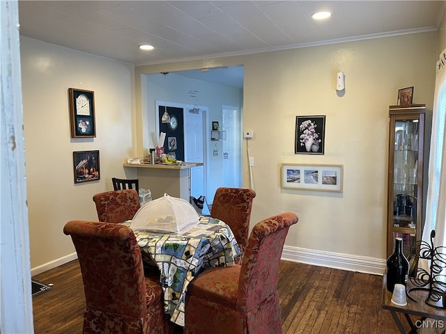 dining room featuring crown molding, recessed lighting, dark wood finished floors, and baseboards