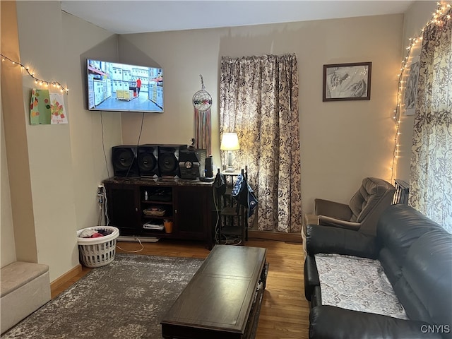 living area with dark wood finished floors and baseboards