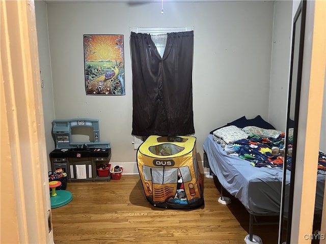 bedroom with wood finished floors