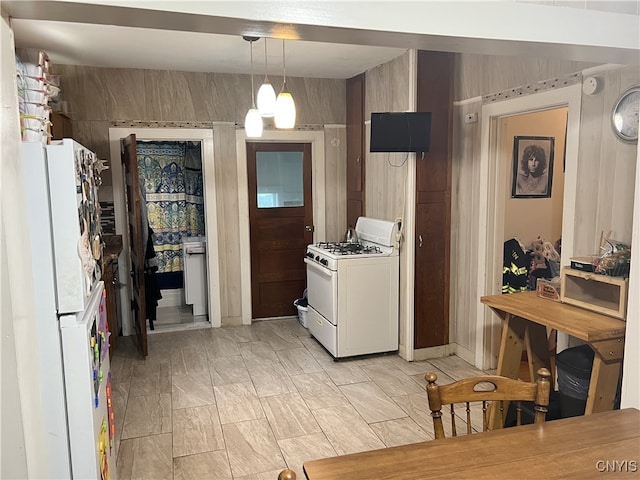 kitchen with white appliances and pendant lighting