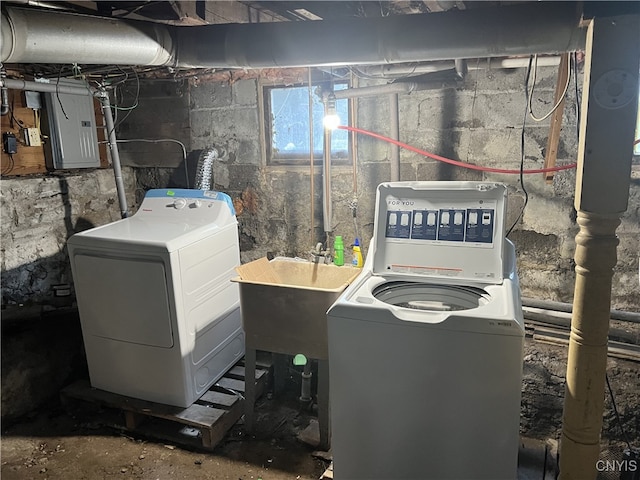 clothes washing area with laundry area, electric panel, independent washer and dryer, and a sink