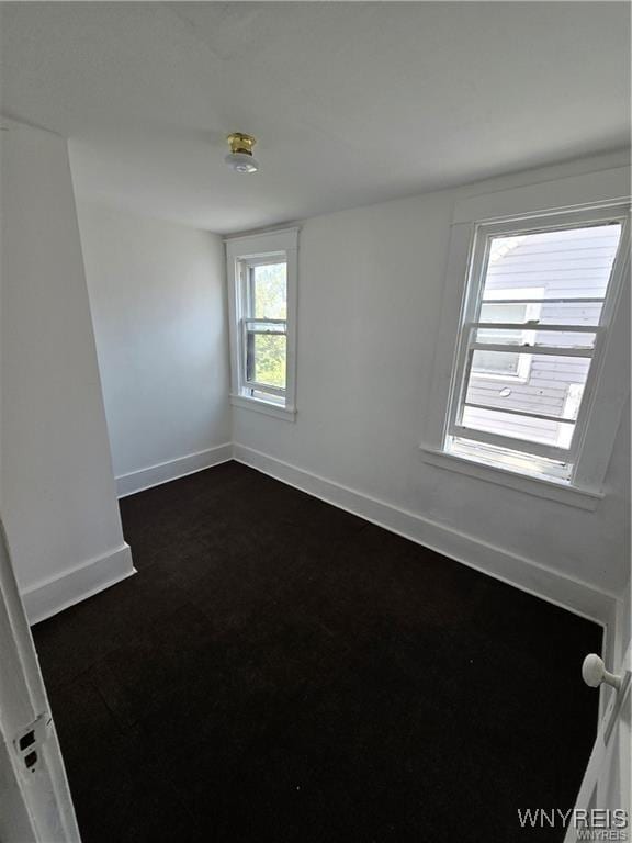 spare room featuring baseboards