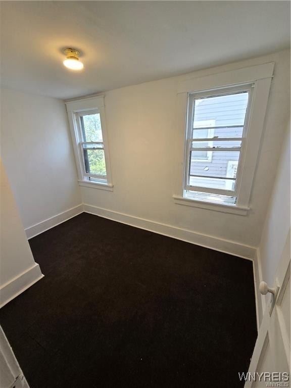 spare room with baseboards