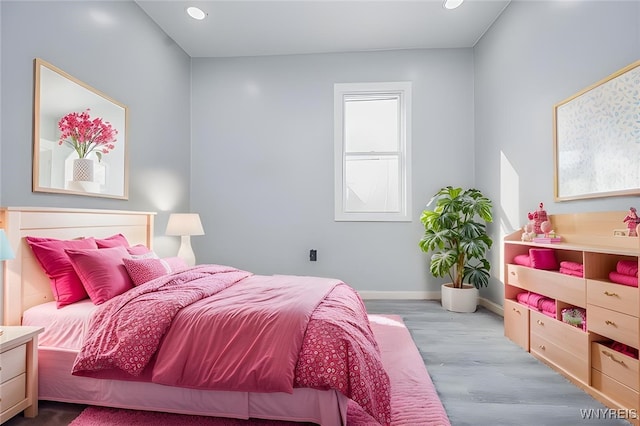 bedroom with baseboards, recessed lighting, and light wood-style floors