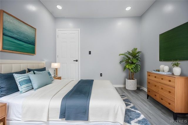 bedroom featuring recessed lighting, light wood-type flooring, and baseboards