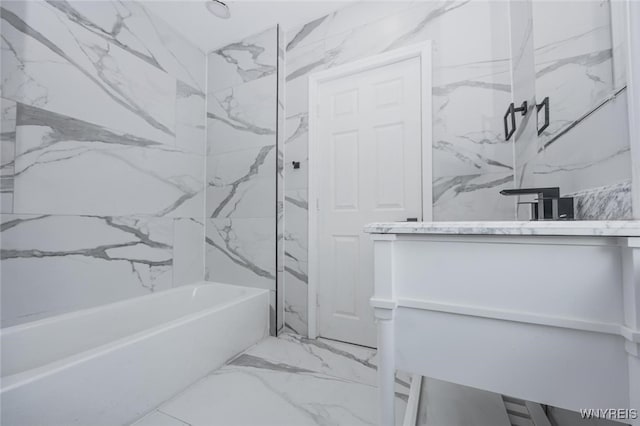 full bathroom with washtub / shower combination, marble finish floor, and vanity