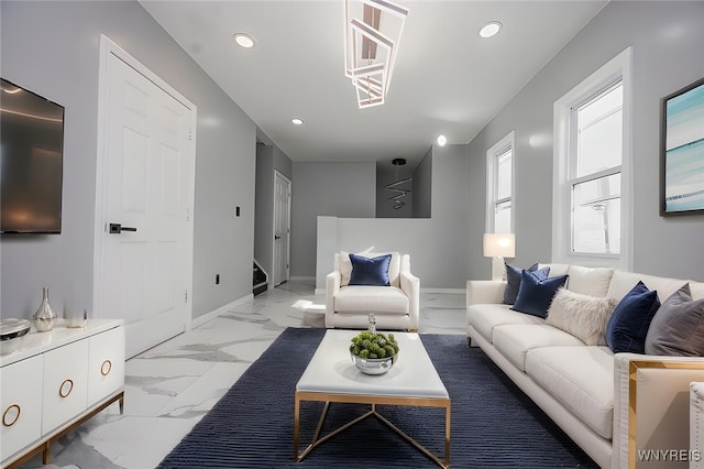 living room with recessed lighting, marble finish floor, and baseboards