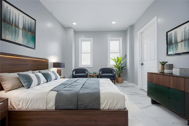 bedroom featuring recessed lighting, marble finish floor, and baseboards