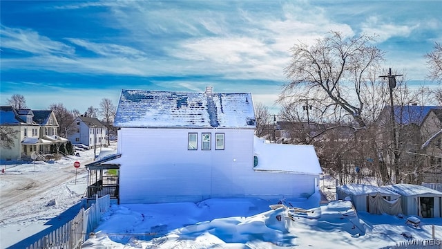 snow covered property featuring a residential view