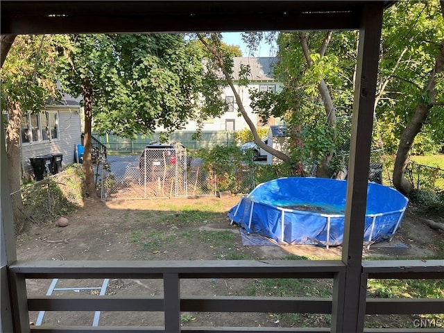 view of yard with fence and a fenced in pool