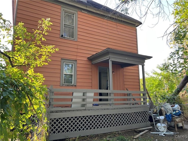 rear view of house featuring a wooden deck