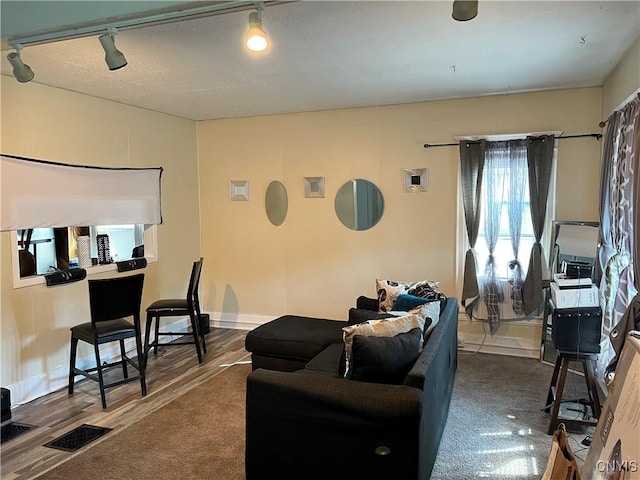 living room with wood finished floors and visible vents