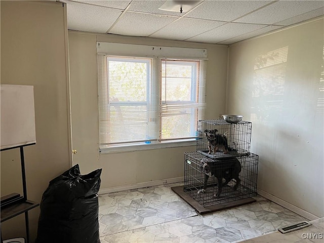 office area featuring a paneled ceiling and baseboards