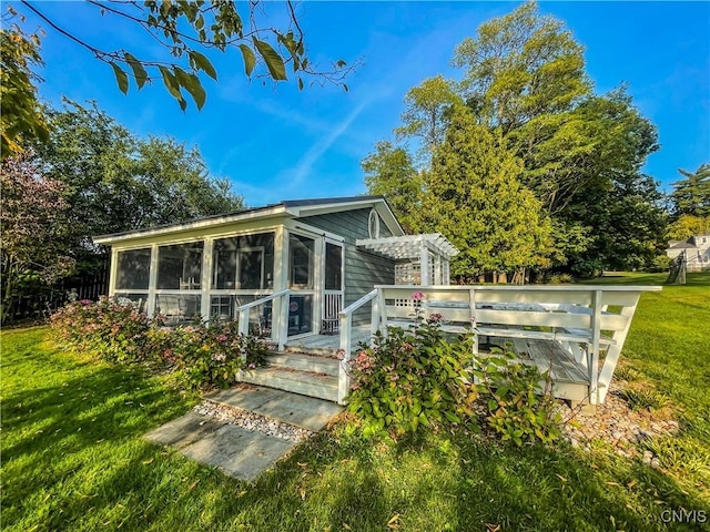 back of house featuring a pergola and a yard