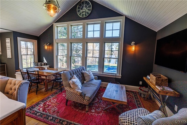 living room featuring vaulted ceiling, wood finished floors, and baseboards