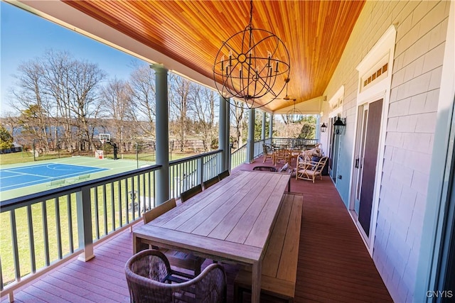 deck with outdoor dining space and a lawn