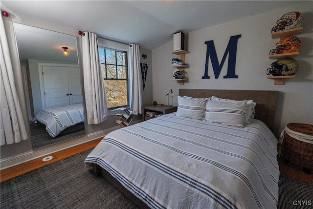 bedroom with dark wood-style flooring