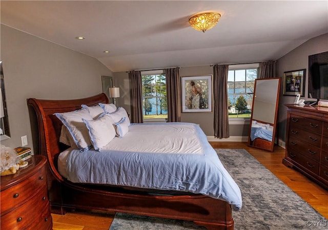 bedroom with lofted ceiling, light wood-style flooring, multiple windows, and recessed lighting