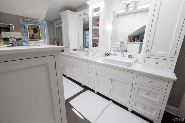 bathroom featuring double vanity and a sink