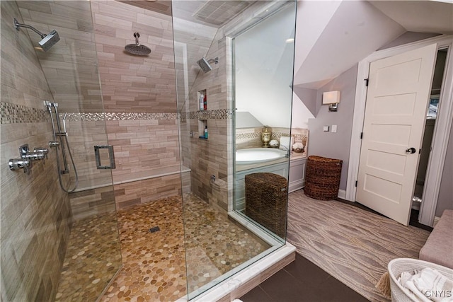 full bath featuring vaulted ceiling, tile patterned flooring, and a shower stall