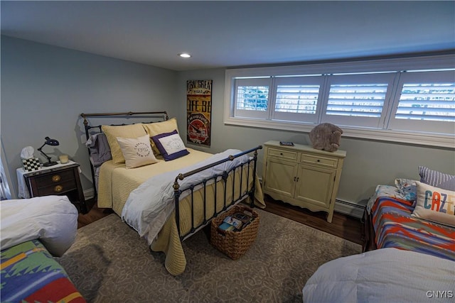 bedroom featuring dark wood-type flooring, recessed lighting, and a baseboard heating unit