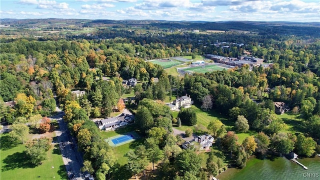 bird's eye view featuring a forest view and a water view